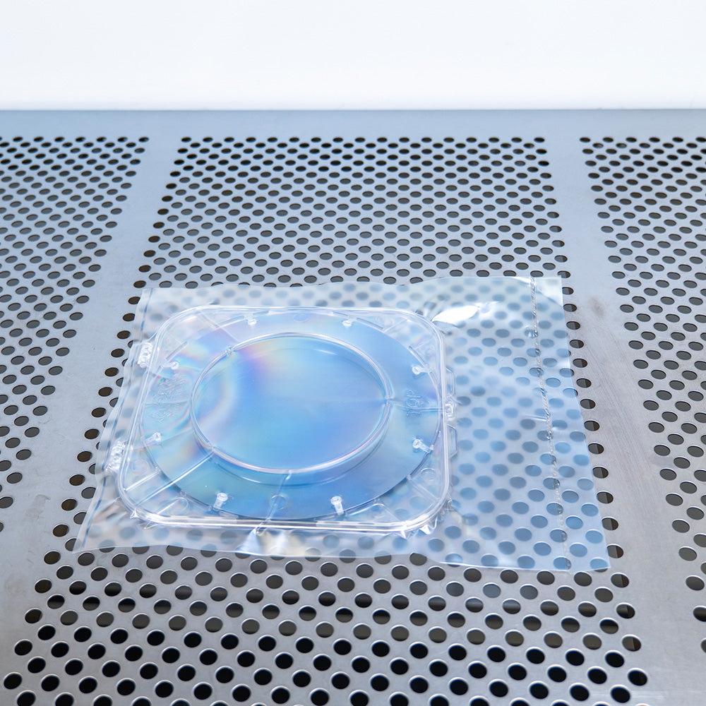 Clamshell single wafer shipper in a vacuum sealed LDPE bag