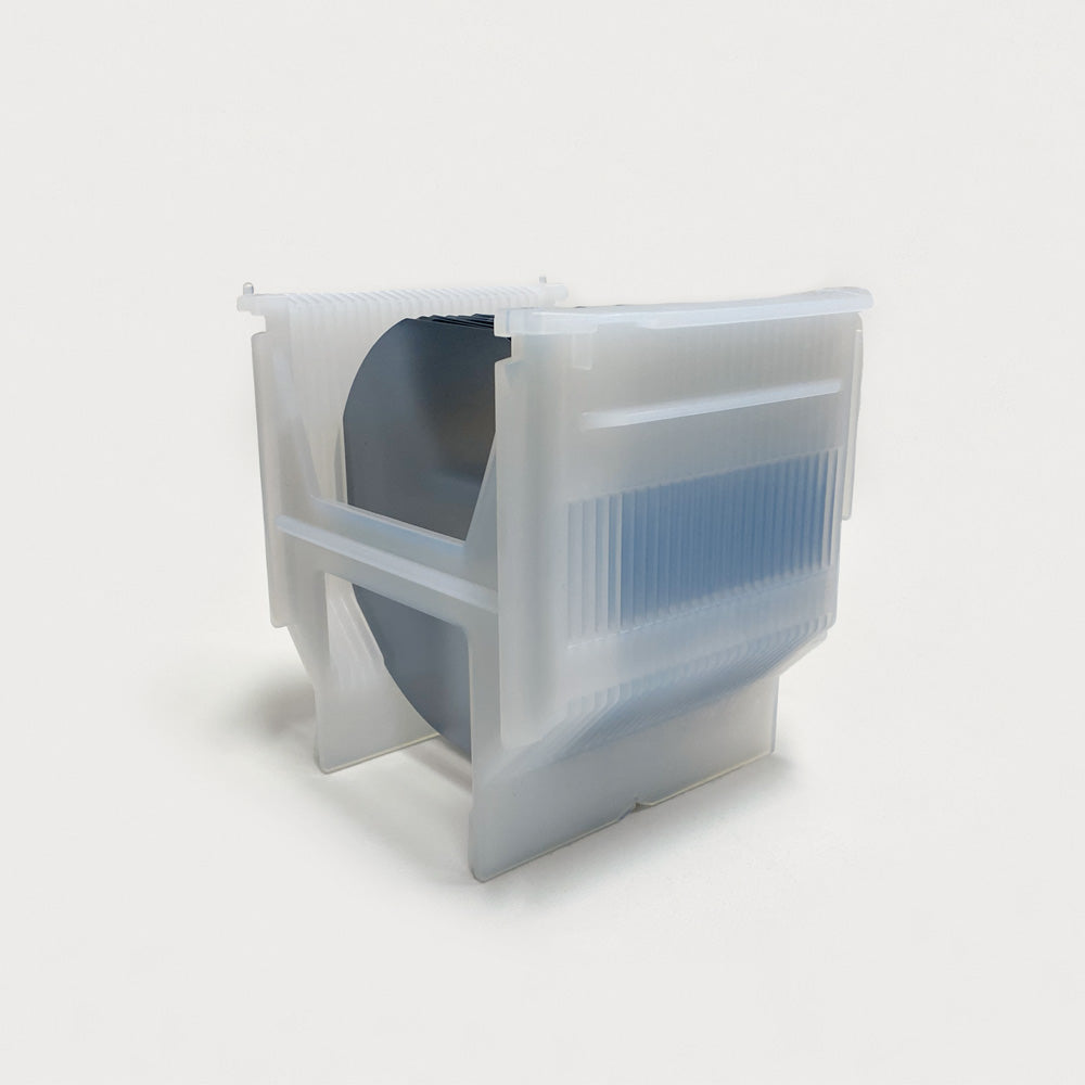 Front-side view of a white cassette made of PFA filled with semiconductor wafers