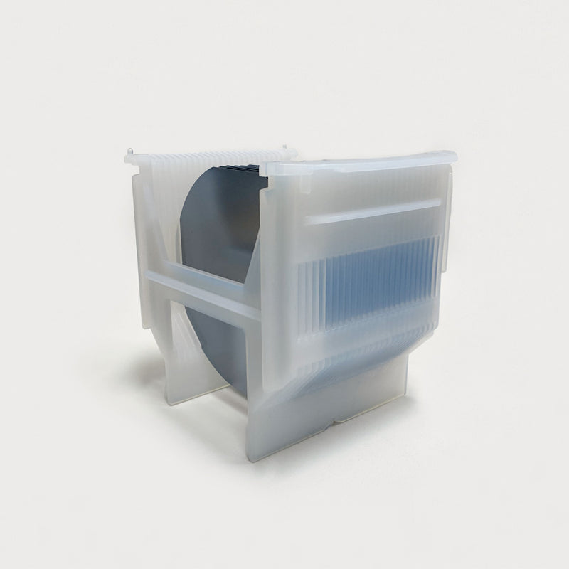 Front-side view of a white cassette made of PFA filled with semiconductor wafers