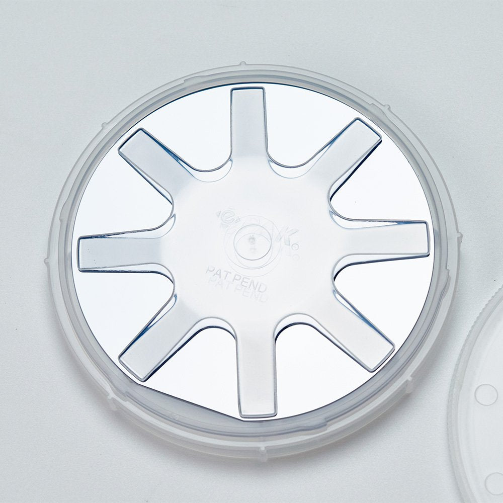 Close up of a 3 inch semiconductor wafer in a natural polypropylene coin style single wafer shipper with spring
