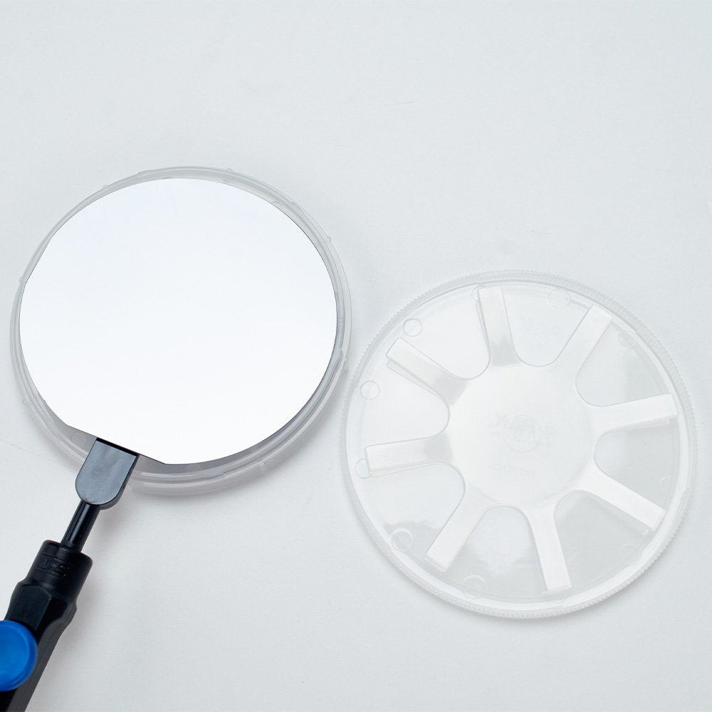 4 inch wafer being placed in a natural polypropylene coin style single wafer shipper by a WHS vacuum wand